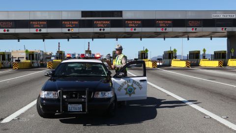 OAKLAND, CA - OCTOBER 28: California Highway Patrol officer Rick Baller stands next to his car as he guards the closed toll plaza leading to the San Francisco Bay Bridge October 28, 2009 in Oakland, California. The San Francisco Bay Bridge was abruptly closed Tuesday evening after two steel tie rods and a crossbeam from a steel saddle broke and fell onto the upper deck of the bridge landing on three vehicles and causing one person to suffer injuries. The eastern span of the bridge is undergoing seismic renovation and is expect to be completed in 2013. (Photo by Justin Sullivan/Getty Images)