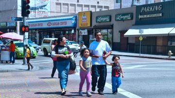 Jose and his family, who are returning to Mexico in a few months as his wife has been deported, cross a street near MacArthur Park in the predominantly Hispanic/Latino neighborhood of Westlake in Los Angeles, California on June 19, 2018. - From cleaning ladies to construction workers to activists, members of LA's huge Latino community say they are horrified by the zero tolerance policy that has led to children being separated from their parents. (Photo by Frederic J. BROWN / AFP) / With AFP Story by Javier TOVAR: US-politics-immigration-children-trauma-health-research (Photo credit should read FREDERIC J. BROWN/AFP via Getty Images)