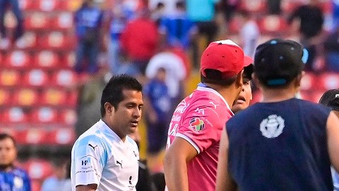 Un aficionado de Atlas protege a una persona en el campo de juego.