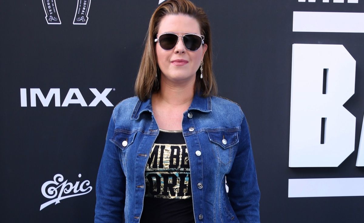 In a string thong, Alicia Machado shows off her figure by posing next to a window