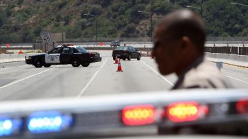 LOS ANGELES, CA - JULY 16: California Highway Patrol officers are seen on one of the busiest freeways in California, the 405, which stands vacant while workers demolish the south side of Mulholland overpass on the freeway during the 53-hour total freeway closure dubbed "Carmageddon" for the resulting massive traffic disruptions expected throughout the region, on July 16, 2011 in Los Angeles, California. The bridge is being demolished part of a $1 billion project to add carpool lanes and make other improvements along the 405 freeway from Orange County to the city of San Fernando. (Photo by David McNew/Getty Images)