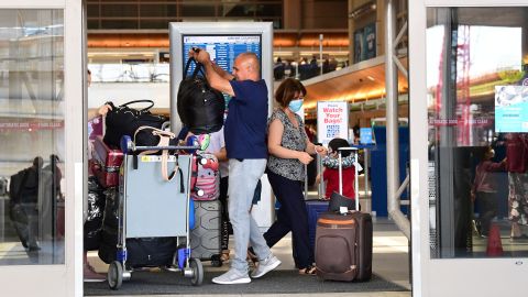 Travelers load their bags at Los Angeles International Airport (LAX) on May 27, 2021 in Los Angeles, as people travel for Memorial Day weekend, which marks the unofficial start of the summer travel season. - Global air passenger numbers could rebound from the coronavirus pandemic to top 2019 levels by 2023, the International Air Transport Association predicted on May 26. (Photo by Frederic J. BROWN / AFP) (Photo by FREDERIC J. BROWN/AFP via Getty Images)