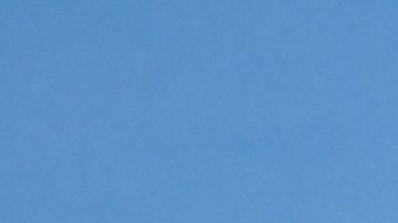 People enjoy the sunny afternoon on New Year's Eve in a Los Angeles park with a view of the downtown skyline, December 31, 2021. (Photo by Chris DELMAS / AFP) (Photo by CHRIS DELMAS/AFP via Getty Images)