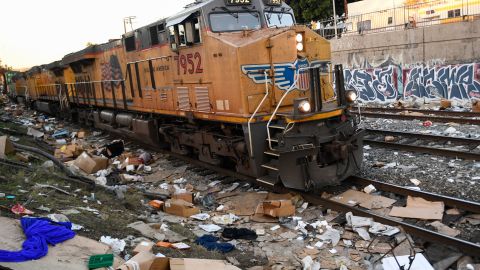 A Union Pacific locomotive passes through a section of tracks littered with thousands of opened boxes and packages stolen from cargo shipping containers, targeted by thieves as the trains stop in downtown Los Angeles, California on January 14, 2022. - Dozens of freight cars are broken into every day in Los Angeles by thieves who take advantage of their stops to loot the packages they carry, leaving thousands of stale boxes and internet-bought goods on the tracks that will never reach their destination. According to the labels found Friday by a team of AFP on a track near downtown, easily accessible from nearby streets, most of the major U.S. mail order and courier companies (Amazon, Target, UPS, Fedex, etc.) were affected by these thefts that have exploded in recent months. (Photo by Patrick T. FALLON / AFP) (Photo by PATRICK T. FALLON/AFP via Getty Images)