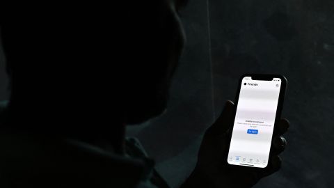 An internet user reads on his mobile phone 'unable to connect' as he tries to log into Facebook Messenger, in Colombo on April 3, 2022. - Armed troops in Sri Lanka blocked an opposition protest march on April 3, staged in defiance of an emergency curfew to protest the island nation's worsening economic crisis, after authorities imposed a social media blackout to contain public dissent. (Photo by Ishara S. KODIKARA / AFP) (Photo by ISHARA S. KODIKARA/AFP via Getty Images)