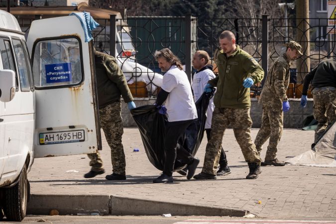 Los soldados ucranianos limpian los cuerpos después de que un ataque con cohetes mató al menos a 39 personas el 8 de abril de 2022 en una estación de tren en Kramatorsk.
