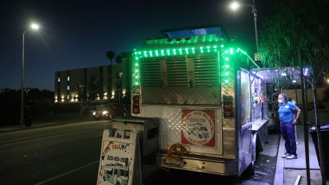 LOS ANGELES, CALIFORNIA - JULY 01: A customer orders from a taco truck amid the COVID-19 pandemic on July 1, 2020 in Los Angeles, California. California Governor Gavin Newsom ordered indoor dining restaurants to close again today in Los Angeles County and 18 other counties for at least three weeks amid a surge in new coronavirus cases. Restaurants and food trucks may remain open for takeout and drive-through orders. (Photo by Mario Tama/Getty Images)