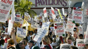 BEVERLY HILLS, CA - DECEMBER 16: Thousands of strikers and supporters rally at a Pavilions supermarket December 16, 2003 in Beverly Hills, California. Locked-out and striking supermarket workers and their supporters held the largest march and rally since the strike began, walking from Century City to the Beverly Hills store to call for a nationwide strike. Seventy-thousand supermarket workers from 860 southern California Ralphs, Vons, Albertsons, and Pavilions stores have been on strike or locked out of their jobs since October 11. (Photo by David McNew/Getty Images)