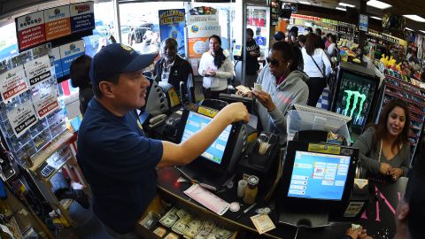 People line up to buy California Powerball lottery tickets at the famous Bluebird Liquor store, considered to be a lucky retailer of tickets, in Hawthorne, California on January 13, 2016. Record sales drove up the largest jackpot in US history to a whopping $1.5 billion as people dreaming of riches flocked across state lines and international borders to buy tickets. / AFP / MARK RALSTON (Photo credit should read MARK RALSTON/AFP via Getty Images)