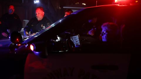 SONOMA, CA - OCTOBER 11: California Highway Patrol officers look over a map of a neighborhood as they go door-to-door to ask residents to voluntarily evacuate as a wildfire approaches on October 11, 2017 in Sonoma, California. Twenty one people have died in wildfires that have burned tens of thousands of acres and destroyed over 3,000 homes and businesses in several Northen California counties. (Photo by Justin Sullivan/Getty Images)