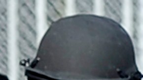 Police and sherriffs deputies maintain a command post outside Gardena High School in Los Angeles January 18, 2010 where two students suffered gunshot wounds after a pistol in a 10th-grader's backpack accidentally discharged when he dropped the bag. AFP PHOTO/Robyn BECK (Photo credit should read ROBYN BECK/AFP via Getty Images)