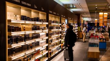 Passengers browse the cosmetics section in a Heinemann duty free shop in terminal 1 at the "Berlin Brandenburg Airport Willy Brandt" in Schoenefeld, south-east of Berlin, on November 6, 2020. - Berlin's new international airport officially opened on Saturday, October 31, 2020, nine years late, massively over-budget and in the middle of a virus-induced air transport crisis. (Photo by Odd ANDERSEN / AFP) (Photo by ODD ANDERSEN/AFP via Getty Images)