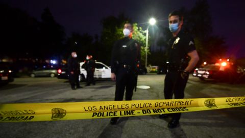 Police tape closes off a street as officers arrive on scene at Echo Park Lake in Los Angeles, March 24, 2021, ahead of a planned and announced cleanup of the encampment as part of an estimated half-million-dollar City of Los Angeles cleanup and repair effort. (Photo by Frederic J. BROWN / AFP) (Photo by FREDERIC J. BROWN/AFP via Getty Images)