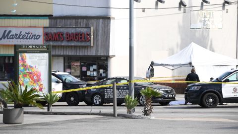 A black vehicle covered with stickers is trapped by police cars at the corner of Fairfax Avenue and Sunset Boulevard where a body covered in a white sheet lies under a tent next to it in Los Angeles on April 24, 2021 in what appears to be an officer-involved shooting. - On the evening of the shooting the LAPD official twitter account read: There has been an Officer-Involved Shooting on Sunset Blvd. near Fairfax in Hollywood Division. Around 2:35 p.m. officers were heading to a radio call with their lights and sirens on when a car pulled in front of them, stopped suddenly and reversed into the police car. The driver of the car exited, was wearing body armor, and had his right hand concealed behind him. He moved toward the officers who had exited their patrol car. He counted "3, 2, 1" and began to move his arm to the front of his body, at which time there was an officer involved shooting. The man was struck by gunfire and pronounced deceased at scene. Force Investigation Division detectives are on scene conducting interviews and gathering evidence.The man who was shot and killed by the Los Angeles Police Department has been identified as 34-year-old Richard Solitro. (Photo by VALERIE MACON / AFP) (Photo by VALERIE MACON/AFP via Getty Images)