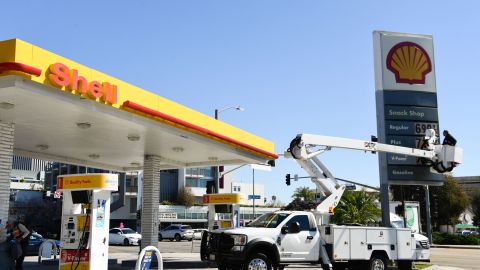 An electrical contractor repairs a sign with gasoline fuel prices above six and seven dollars a gallon at the Shell gas station at Fairfax and Olympic Blvd in Los Angeles, California, on March 8, 2022. (Photo by Patrick T. FALLON / AFP) (Photo by PATRICK T. FALLON/AFP via Getty Images)