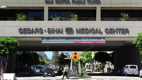 A pedestrain crosses a street at Cedars-Sinai Medical Center in Los Angeles on September 7, 2012 in California, where veteran French rocker Johnny Hallyday underwent examinations this week following a health scare in the Caribbean. Hallyday's manager Sebastien Farran said the “general” tests on the 69-year-old singer were due to be finished Friday” with Hallyday released from hospital. AFP PHOTO / Frederic J. BROWN (Photo credit should read FREDERIC J. BROWN/AFP/GettyImages)