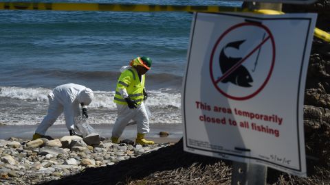 Workers clean oil from the rocks and beach at Refugio State Beach in Goleta, California, May 22, 2015. The oil company behind a crude spill on the California coast vowed to do the "right thing" to clear up the mess, even as reports emerged of past leaks involving its pipelines. Plains All American Pipeline made the pledge as it said nearly 8,000 gallons of oil had been scooped up, out of some 21,000 gallons believed to have flooded into the ocean near Santa Barbara, northwest of Los Angeles. AFP PHOTO/ MARK RALSTON (Photo credit should read MARK RALSTON/AFP via Getty Images)