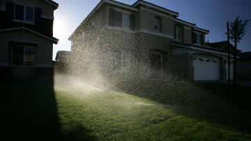 HESPERIA, CA - JULY 28: Sprinklers water the lawns of a new housing development July 28, 2005 in Hesperia, California. California's demand for water will jump by 40 percent over the next 25 years according to a study released this week by the Public Policy Institute of California. Half of all the water used by inland homeowners, where growth is booming, goes to irrigating yards, compared to one third or less in the cooler coastal regions. (Photo by David McNew/Getty Images)