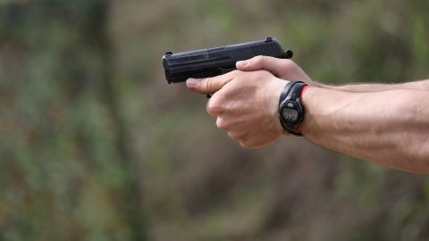 BANDERA, TX - APRIL 13: A U.S. Border Patrol agent fires a handgun during a shooting contest on April 13, 2017 in Bandera, Texas. The gun competition was part of "Demo Day" events where participants at the annual Border Security Expo were able to test their skills, often with the latest weaponry. The annual border expo brings together government officials and private sector firms promoting new technology on sale for use on the U.S. southern border with Mexico. (Photo by John Moore/Getty Images)