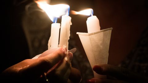 TOPSHOT - People hold candles as they pray during a candlelight vigil at the Immanuel Church for victims of a shooting that left a total of 22 people dead at the Cielo Vista Mall WalMart in El Paso, Texas, on August 5, 2019. - US President Donald Trump on Monday told a nation mourning 31 people killed in two mass shootings that he rejected racism and white supremacist ideology, moving to blunt criticism that his divisive rhetoric fuels violence. Trump will visit El Paso, Texas, on Wednesday following a mass shooting in the southern border town that killed 22 people, the local mayor said. (Photo by Mark RALSTON / AFP) (Photo credit should read MARK RALSTON/AFP via Getty Images)