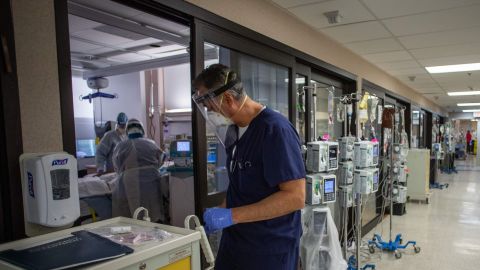 Doctor Thomas Yadegar closes the door of one Intensive Care Unit (ICU) after attending a Covid-19 patient in the Intensive Care Unit (ICU) at Providence Cedars-Sinai Tarzana Medical Center in Tarzana, California on December 18, 2020. (Photo by Apu GOMES / AFP) (Photo by APU GOMES/AFP via Getty Images)