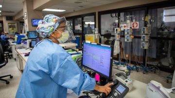 Registered nurse Carmen Verano answers a phone call in the Intensive Care Unit (ICU) at Providence Cedars-Sinai Tarzana Medical Center in Tarzana, California on December 18, 2020. (Photo by Apu GOMES / AFP) (Photo by APU GOMES/AFP via Getty Images)