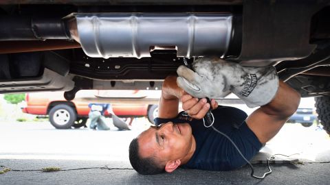 Deputy Jaime Moran from the Los Angeles Sheriffs Department engraves the catalytic converter of a vehicle with a traceable number on July 14, 2021, in City of Industry, California. - Theft of catalytic converters across the US have soared over the course of the Covid-19 pandemic, valuable to scrap metal dealers for the precious metals including rhodium, platinum and palladium. (Photo by FREDERIC J. BROWN / AFP) (Photo by FREDERIC J. BROWN/AFP via Getty Images)