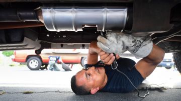 Deputy Jaime Moran from the Los Angeles Sheriffs Department engraves the catalytic converter of a vehicle with a traceable number on July 14, 2021, in City of Industry, California. - Theft of catalytic converters across the US have soared over the course of the Covid-19 pandemic, valuable to scrap metal dealers for the precious metals including rhodium, platinum and palladium. (Photo by FREDERIC J. BROWN / AFP) (Photo by FREDERIC J. BROWN/AFP via Getty Images)