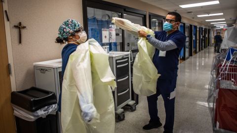 Registered nurses Christie Lindog (L) and Raul Gutierrez prepare to check a patient with Covid-19 at the Cardiovascular Intensive Care Unit at Providence Cedars-Sinai Tarzana Medical Center in Tarzana, California on September 2, 2021. - According to Dr. Yadegar at the hospital, the number of covid patients are significantly less than they were in winter, but from a psychological standpoint it's much more difficult because most of the patients in the ICU on respirators are unvaccinated, younger and healthier 30 and 40 year olds without comorbidities. Vaccinated patients at the hospital are typically older, but the Covid-19 effects are much milder compared to the unvaccinated patients that have more severe symptoms. (Photo by Apu GOMES / AFP) (Photo by APU GOMES/AFP via Getty Images)