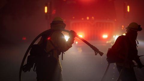 GOLETA, CA - OCTOBER 12: Firefighters battle the Alisal Fire at night on October 12, 2021 near Goleta, California. Pushed by high winds, the Alisal Fire grew to 6,000 acres overnight, shutting down the much-traveled 101 Freeway along the Pacific Coast. (Photo by David McNew/Getty Images)