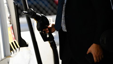 A customer returns a nozzle to a pump after fueling gasoline into a sport utility vehicle (SUV) at a Shell gas station in the Chinatown neighborhood of Los Angeles, California, on February 17, 2022. - In Los Angeles County, a new record for gas prices has now been set for the 11th time in 12 days. The average price of a gallon of self-serve regular is now $4.77 per gallon, up more than 10 cents over the past 16 days. (Photo by Patrick T. FALLON / AFP) (Photo by PATRICK T. FALLON/AFP via Getty Images)