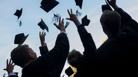 LEIPZIG, GERMANY - AUGUST 30: Graduates in gown and caps celebrate their graduation at the HHL Leipzig Graduate School of Management on August 30, 2014 in Leipzig, Germany. A total of 167 students in various Masters programs of business management graduated today, including the regular MBA program, whose students are 80% from foreign countries, while the more advanced graduate programs have a higher percentage of German-born students. (Photo by Jens Schlueter/Getty Images)