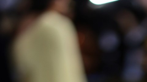 Elon Musk con un traje frac y mirando sobre su hombro