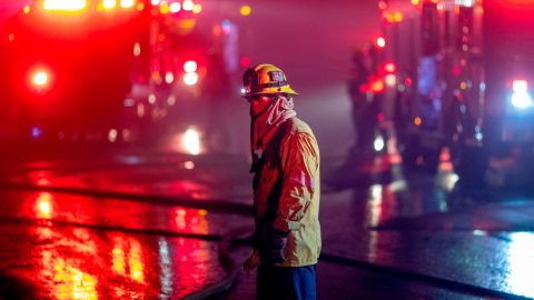 Firefighters work to save homes from the Saddleridge Fire in the Porter Ranch section of Los Angeles, California, on October 11, 2019. - The fire broke out late October 10 and has scorched some 4,600 acres (1,816 hectares), and forced mandatory evacuation orders for 12,700 homes. (Photo by DAVID MCNEW / AFP) (Photo by DAVID MCNEW/AFP via Getty Images)