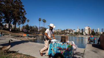 A ice-cream street vendor pushes his cart in MacArthur Park, Los Angeles on May 21, 2020. - Undocumented immigrants impacted by the corornavirus shutdown can apply for California coronavirus emergency assistance plan for undocumented people put in place by Governor Gavin Newsom in April. (Photo by Apu GOMES / AFP) (Photo by APU GOMES/AFP via Getty Images)