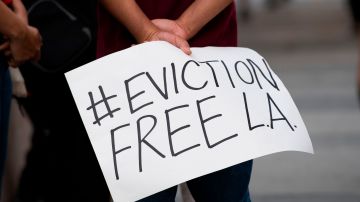 Renters and housing advocates attend a protest to cancel rent and avoid evictions amid Coronavirus pandemic on August 21, 2020, in Los Angeles, California. (Photo by VALERIE MACON / AFP) (Photo by VALERIE MACON/AFP via Getty Images)