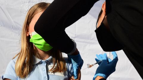 A child receives a dose of Pfizer's Covid-19 vaccine at an event launching school vaccinations in Los Angeles, California on November 5, 2021. - The United States can now start giving children aged 5-11 the Pfizer-BioNtech Covid vaccine, US health authorities said Tuesday in a move hailed by President Joe Biden as a "turning point" in the fight against the pandemic. (Photo by Frederic J. BROWN / AFP) (Photo by FREDERIC J. BROWN/AFP via Getty Images)