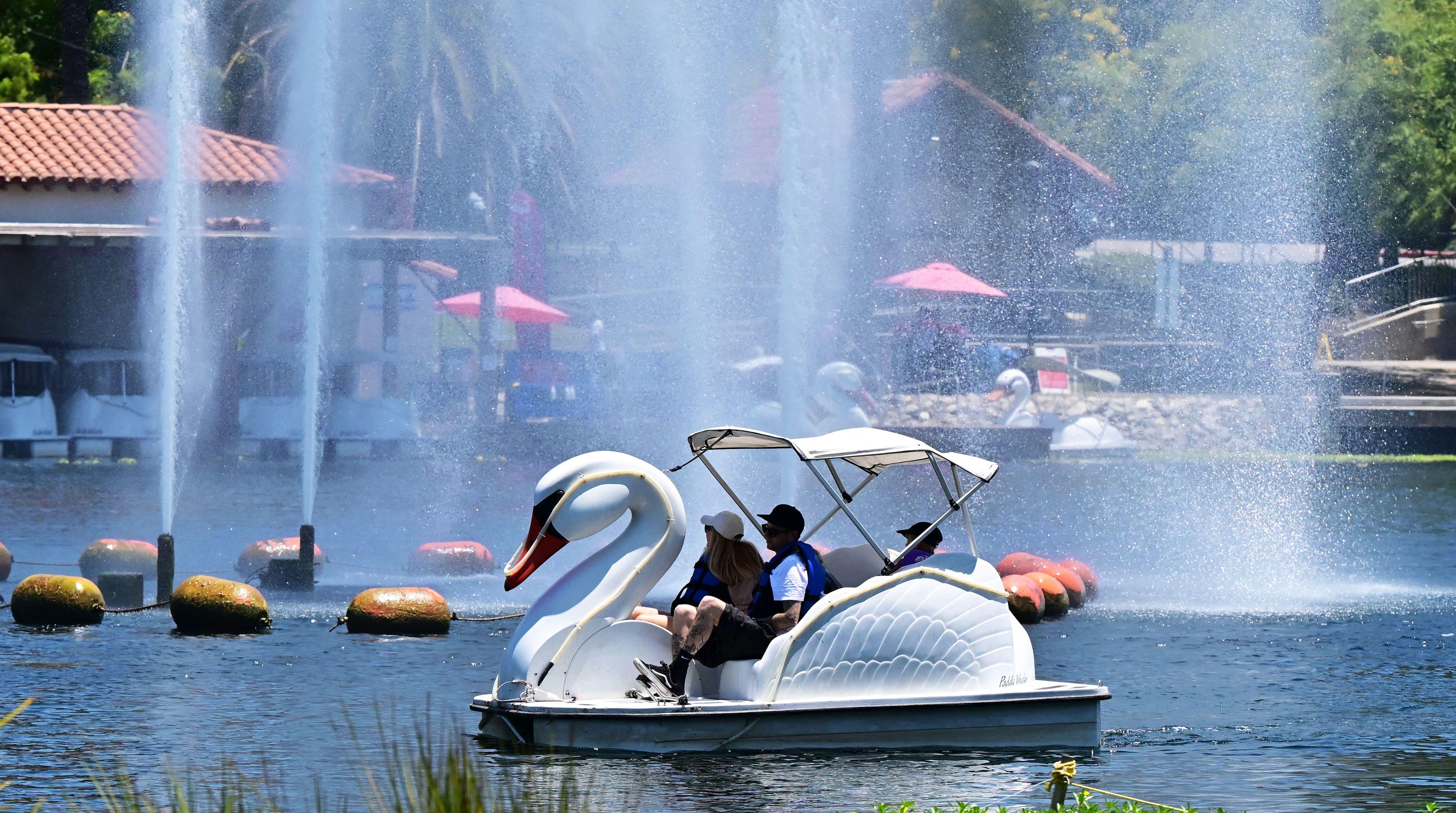 People cool off in a rowboat on the lake at Echo Park in Los Angeles.