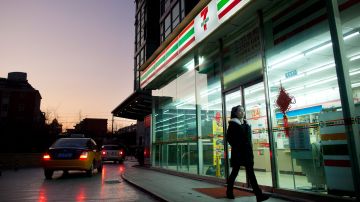 A woman walks past a 7-Eleven convenience store in Beijing on January 3, 2012. There are some 600 7-Eleven stores in the Chinese capital, though plans to launch a franchising business in Shanghai in 2012 to accelerate expansion amid keen market competition were announced by 7-Eleven Inc. in December 2011. Globally, 7-Eleven operates, franchises, or licenses more than 43,000 stores in 16 countries, mostly in the Asia Pacific. AFP PHOTO / ED JONES (Photo credit should read Ed Jones/AFP via Getty Images)