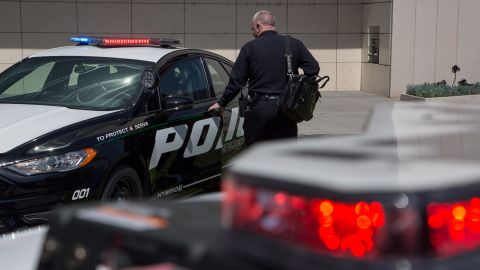 LOS ANGELES, CA - APRIL 10: An LAPD officer looks at a car at the unveiling of two new Ford Fusion hybrid pursuit-rated Police Responder cars at Los Angeles Police Department headquarters on April 10, 2017 in Los Angeles, California. The LAPD is committed to purchasing at least 300 hybrid and hybrid-electric plug-in vehicles by 2020. (Photo by David McNew/Getty Images)