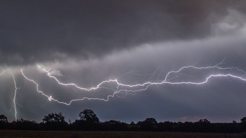 Lightnings flashes through the sky near Sieversdorf, eastern Germany, on August 1, 2017. / AFP PHOTO / dpa / Patrick Pleul / Germany OUT (Photo credit should read PATRICK PLEUL/DPA/AFP via Getty Images)