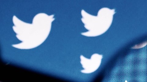 Una lupa que apunta a uno de los logotipos de la aplicación Twitter.