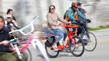A woman rides an Uber JUMP e-bike in car-free streets during a CicLAvia event in Culver City on March 3, 2019. - CicLAvia is a non-profit organization that hosts events where people can bike, walk, skate and stroll on car-free streets. (Photo by Chris Delmas / AFP) (Photo credit should read CHRIS DELMAS/AFP via Getty Images)