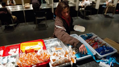 TO GO WITH AFP STORY by Laurent VU THE, Canada-society-drugs-health A client of the Insite supervised injection Center in Vancouver, Canada, collects her kit on May 3, 2011. The Canadian Supreme Court is to settle a conflict between the government's wishes to close the center and the center's success in fighting the spread of AIDS among drug addicts. In eight years of existence, and with more 600 visits per day on average, Insite believes it has made advances in the fight against AIDS. And in a radius of 500 meters around the center, deaths by overdose dropped by 35 percent since the opening, according to a study published in the medical newspaper The Lancet. AFP PHOTO/Laurent Vu The (Photo credit should read Laurent Vu The/AFP via Getty Images)