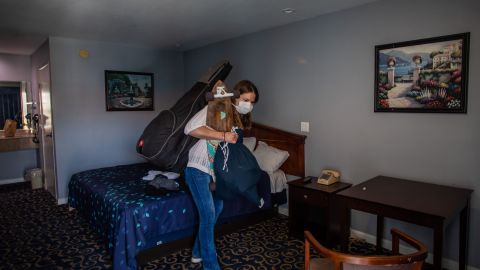 Julie Mariane gathers her belongings in a motel room provided to homeless people by the NGO St. Joseph Center, as she gets ready to be transferred to a hotel room in Venice Beach, California on April 26, 2020. - Julie has been living in the street for one and a half years. The NGO St. Joseph Center is providing Hotel rooms to the homeless people at risk or infected with Covid-19, through Project Roomkey of the City of Los Angeles. (Photo by Apu GOMES / AFP) (Photo by APU GOMES/AFP via Getty Images)