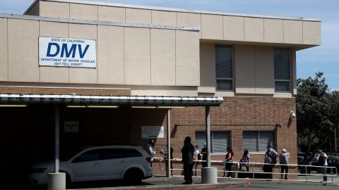 SAN FRANCISCO, CALIFORNIA - MAY 08: People wait in line to enter a California Department of Motor Vehicles (DMV) office on May 08, 2020 in San Francisco, California. The California DMV has opened up 25 of its offices throughout the state to assist customers with appointments and services that may require an in-person visit. The DMV temporarily closed all offices in California on March 27 due to coronavirus (COVID-19). (Photo by Justin Sullivan/Getty Images)