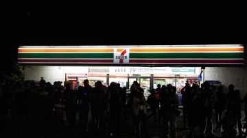 Protestors and press line up in front of a 7 Eleven shop in Portland, on September 4, 2020 during a march to denounce police brutality and racism. - Portland this weekend marks 100 days since protests erupted in the western US city to denounce police brutality and racism, shining a spotlight on a deeply polarized America as it prepares for high-stakes elections. The nightly protests, sparked by the death of an African American while in police custody in Minneapolis in May, escalated sharply in the Oregon city after the administration deployed federal agents to protect federal property from damage. (Photo by Allison Dinner / AFP) (Photo by ALLISON DINNER/AFP via Getty Images)