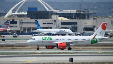 A Viva Aerobus Airbus SE A320 flight arrives from Mexico as a JetBlue aircraft stands on the tarmac at Los Angeles International Airport (LAX) on July 6, 2021 in Los Angeles, California. - The LAX airport celebrates 60 years since the opening of the "Jet Age" terminals and Theme Building as a $14.5 billion airport infrastructure modernization and transit construction project continues ahead of the 2028 Los Angeles Olympics. (Photo by Patrick T. FALLON / AFP) (Photo by PATRICK T. FALLON/AFP via Getty Images)