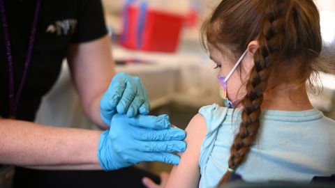 A nurse administers a pediatric dose of the Covid-19 vaccine to a girl at a L.A. Care Health Plan vaccination clinic at Los Angeles Mission College in the Sylmar neighborhood in Los Angeles, California, January 19, 2022. - While cases of Covid-19 hospitalizations and deaths continue to rise in California, officials are seeing early signs that the Omicron surge is slowing. (Photo by Robyn Beck / AFP) (Photo by ROBYN BECK/AFP via Getty Images)