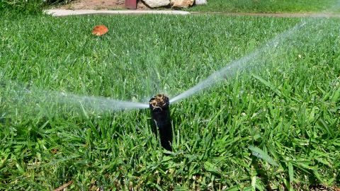 An automated sprinkler waters grass in front of homes in Alhambra, California on April 27, 2022, a day after Southern California delared a water shortage emergency with unprecedented new restrictions on outdoor watering for millions of people living in Los Angeles, San Bernardino and Ventura counties. - Southern California's Metropolitan water district will allow for outdoor watering tp just one day per week effective June 1st. (Photo by Frederic J. BROWN / AFP) (Photo by FREDERIC J. BROWN/AFP via Getty Images)